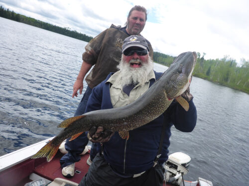 Fisherman Holding Massive Northern Pike Catch on Dog Lake