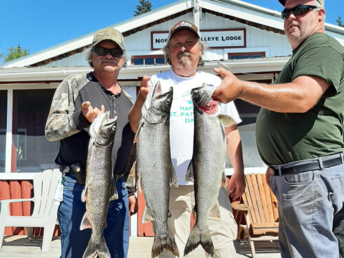 Group With Massive Lake Trout by the Lodge