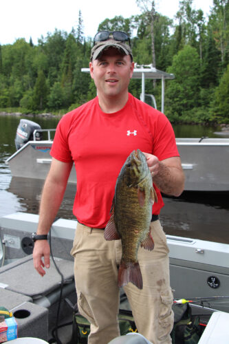 Guest in Boat Holding Bass
