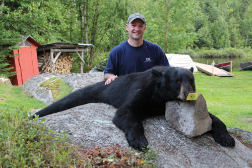 Guest with Black Bear After Hunt