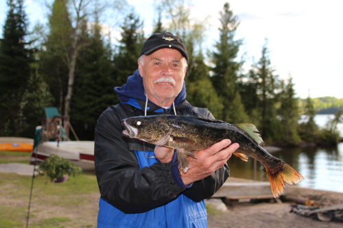 Guest with Walleye Catch by the Docks