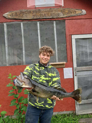 kid with big lake trout catch