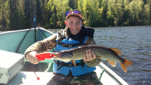 Yound Child Holding up Northern Pike Catch